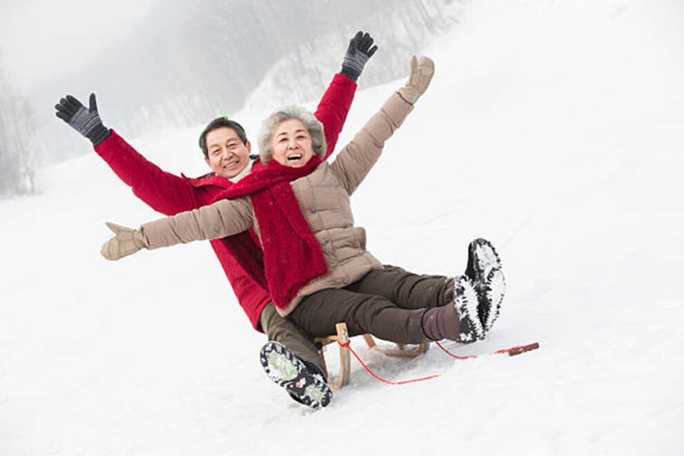 Happy couple on a sled in the wintertime